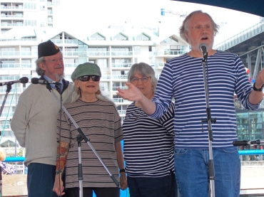 Explaining a song at Granville Island Wooden Boat Festival, 2018